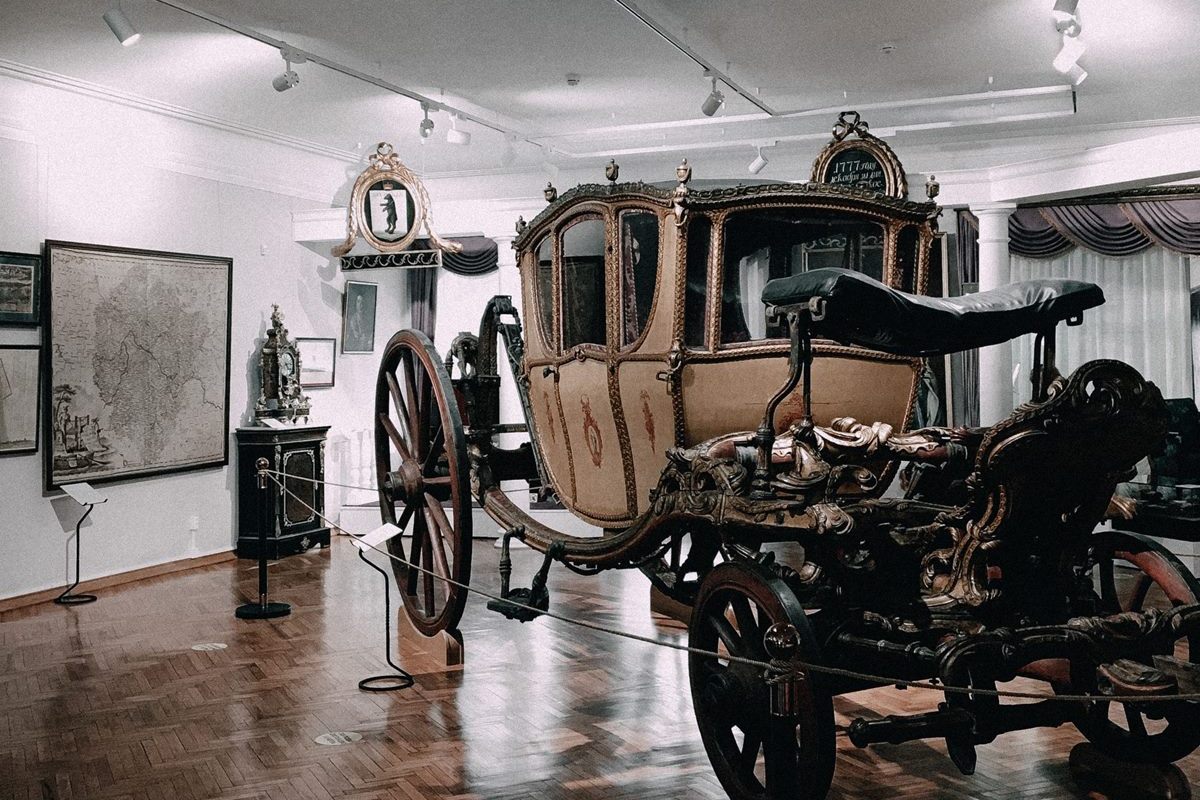 Museum gallery with a historic carriage on display